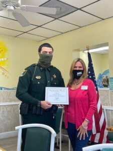 Deputy Angel Falcon receives his Deputy of the Month award from FMB President Jacki Liszak.