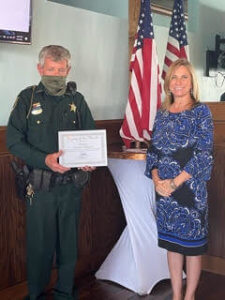 FMB Chamber President Jacki Liszak presents the deputy of the month award to Deputy Kenny Tillman.