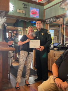 Angel Falcon receives his Deputy of the Month award from FMB Chamber President Jacki Liszak.