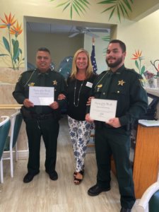 President Jacki Liszak with Lee County Sheriff Deputies Deputy Julian Chavez and Deputy Daniel Ochs.