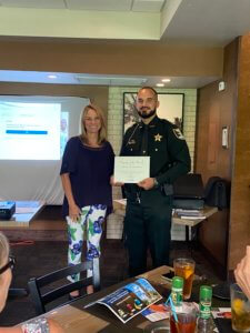 John Montesino, the June Deputy of the Month, receives his award at the Chamber luncheon.
