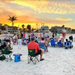 People enjoy an Easter sunrise service on the beach.