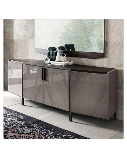 Modern console table with a large mirror above it, decorated with glass vases, books, and a small metallic sculpture.